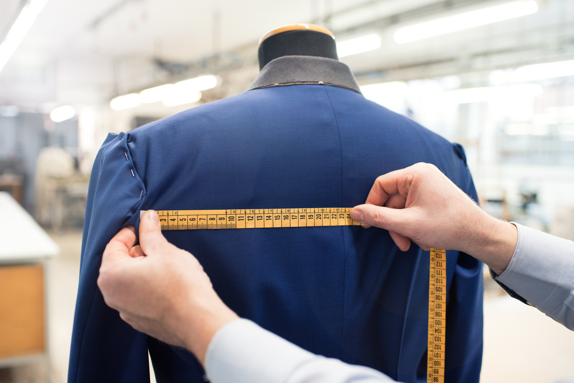 Tailor Doing Jacket Measurement in Workshop